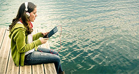 Girl Wearing Headphones On Dock