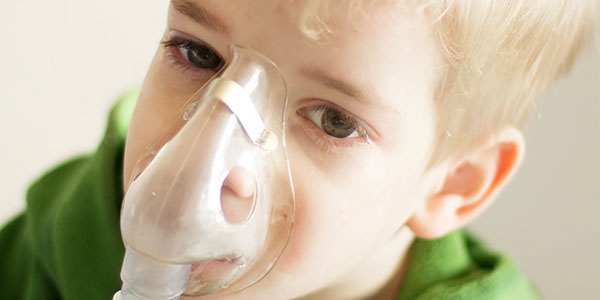 Boy with asthma mask