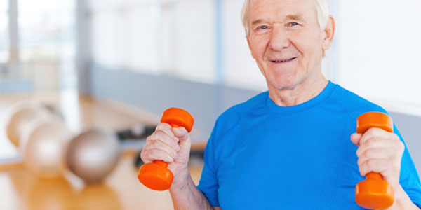 Elderly man exercising with free weights