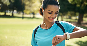 Woman checking fitness device