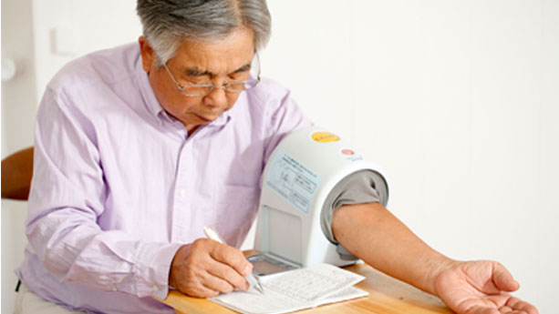 Man taking blood pressure at home