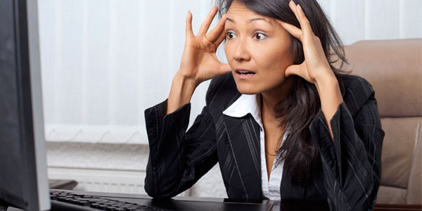 Asian woman stressed looking at office computer