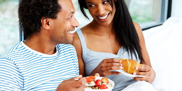African-American couple eating breakfast
