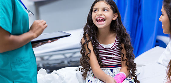 Little girl laughing in hospital with arm cast