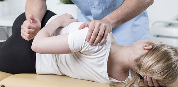 Woman laying on a chiropractic table being adjusted