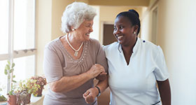 Smiling caregiver and senior woman