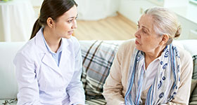 Female doctor and older patient having serious conversation