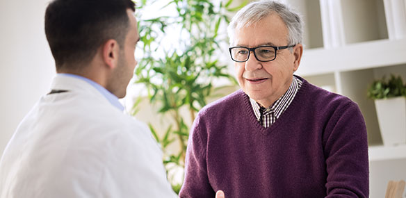 Mature male patient in discussion with doctor