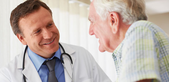 Doctor in discussion with elderly male