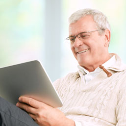 Elderly man viewing digital tablet