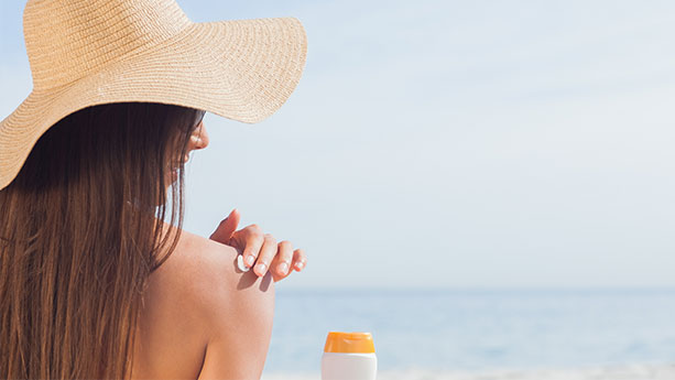 Woman putting sunscreen on