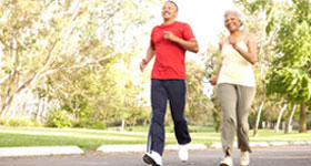 Middle-aged African-American couple jogging