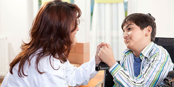 Disabled boy and doctor handshake