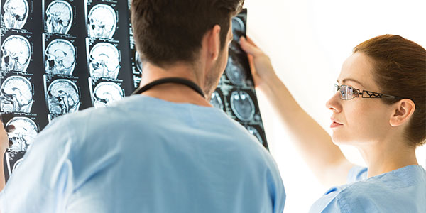 Doctors examining MRI brain scans