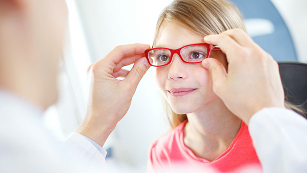 young caucasian girl being fitted for eye glasses