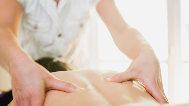 Therapist massaging patient's back