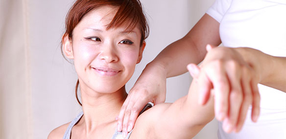 Asian woman getting shoulder massaged
