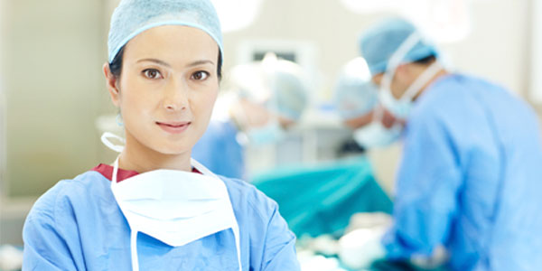 Female Asian surgeon in operating room