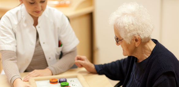 Female doctor conducting memory test on elderly female patient