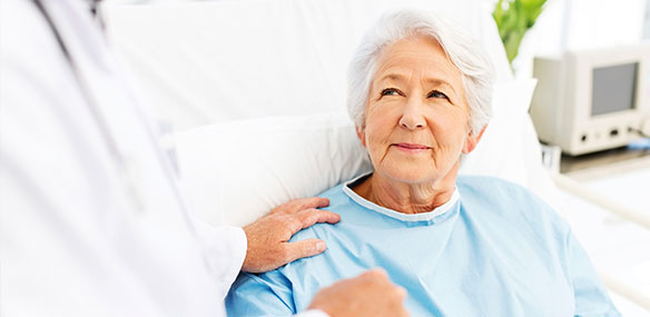 Senior woman in hospital bed with concerned look