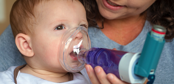 Baby with asthma inhaler