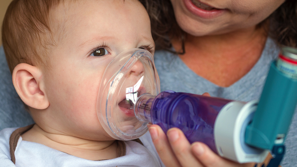 Baby with asthma inhaler