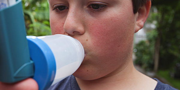 Boy with asthma inhaler