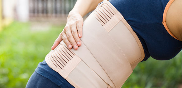 Woman bending with back brace