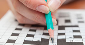 Person doing a crossword puzzle