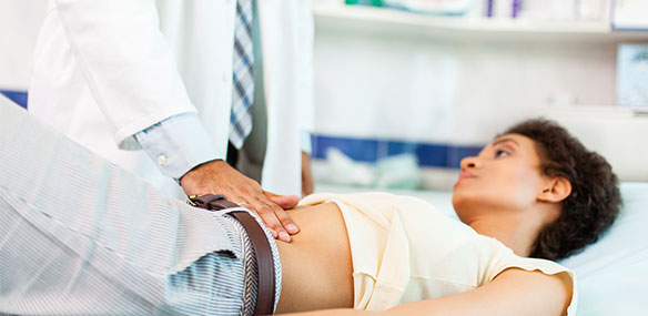 Woman with stomachache having medical exam