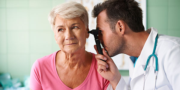 Doctor looking in patient's ear