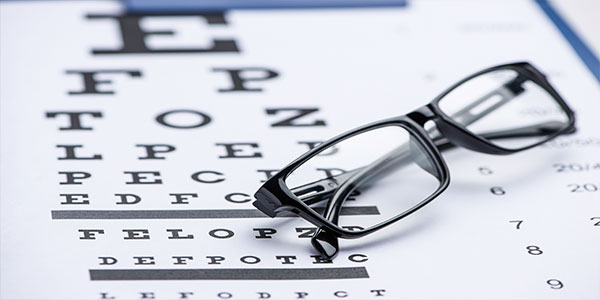 eye glasses and eye chart