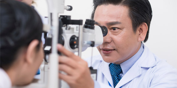Optometrist examining eyes