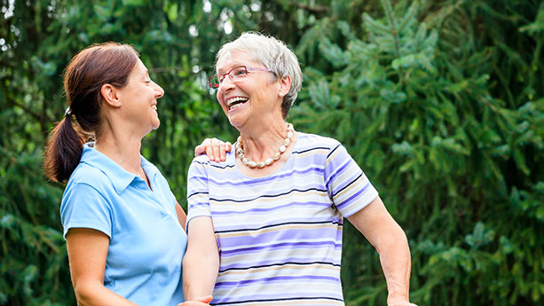 Caregiver helping elderly woman