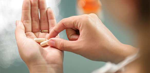 Close up of supplements in female hands