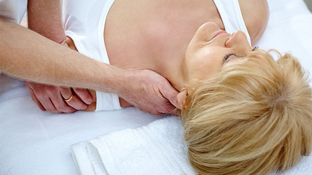 Chiropractor stretching patient's neck