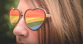 Teen with rainbow heart sunglasses