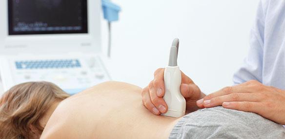 Patient receiving ultrasound on lower back