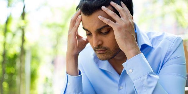 East Indian man with headache
