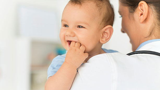 Pediatrician holding baby