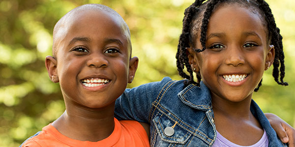 two young african american children smiling