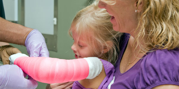 Young girl getting cast on arm