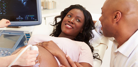 African-American couple watching pregnancy ultrasound