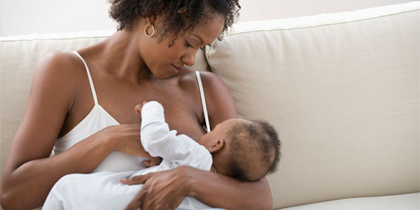 African-American woman breastfeeding baby