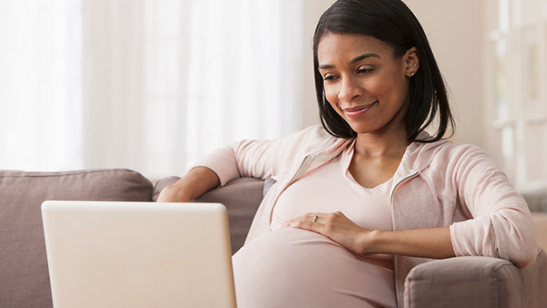 pregnant african american woman using computer