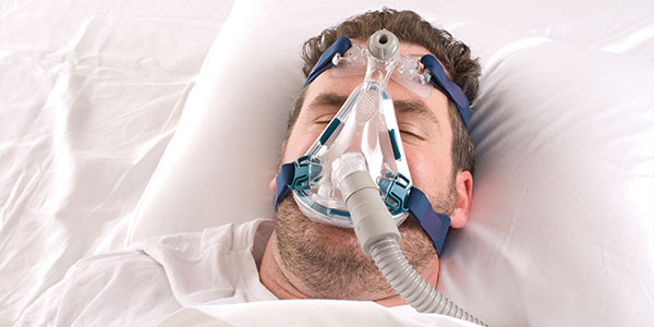 Man with sleep apnea machine