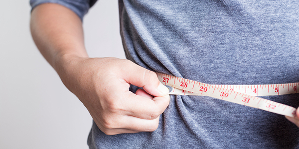 measuring waist with a tape measure