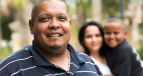 Obese African-American man with family in the background