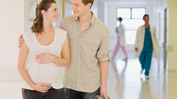 pregnant woman and husband touring hospital
