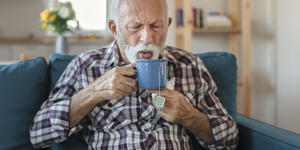 Older man drinking tea